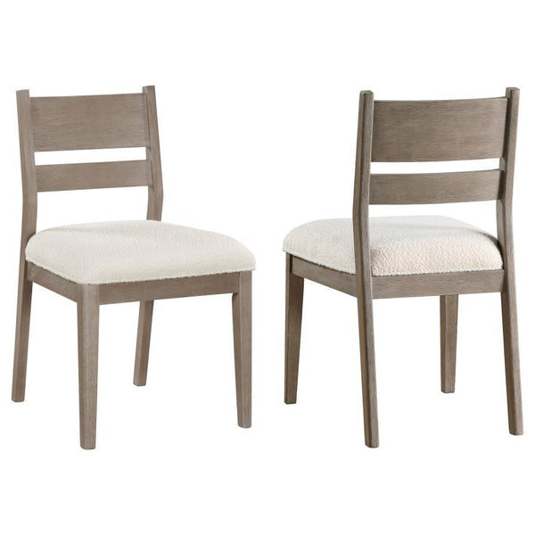Upgrade your dining table with a set of two modern farmhouse side chairs. Perfect for a casual kitchen table, they feature coastal character with a grey wood finish that offers subtle wood grain patterning. Upholstery is a creamy white with wonderful text