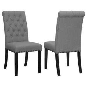 Blending timeless elegance with plush comfort, this side chair enhances any dining space. Its high backrest features a classic button-tufted design, adding depth and sophistication. A rolled top and hand-applied nailhead trim create refined detailing, whi