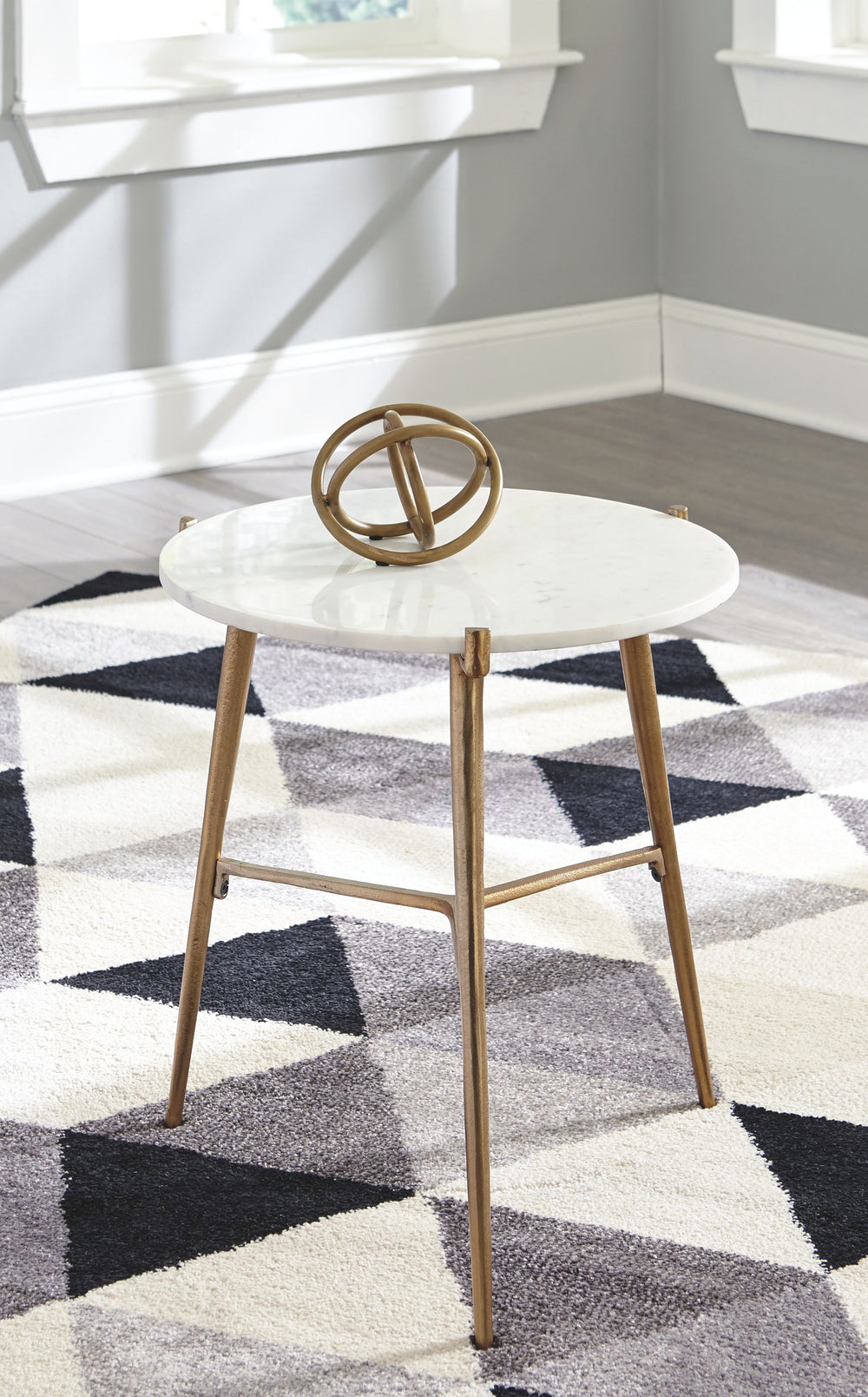 Take a stance for clean, contemporary style with this accent table. Its round white marble top is paired with an antiqued goldtone tripod base. The result: an ultra-rich aesthetic priced to entice.<br/><br/><b>Product Features</b><ul><li>White marble tabl