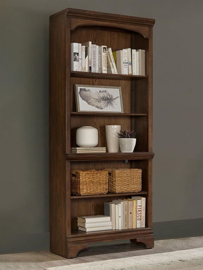 A traditional style bookcase is an elegant addition to offices and home libraries. This piece features five roomy shelves with plenty of space to arrange your favorite novels. Elegant detailing includes a stacked design on the top of the frame with a curv