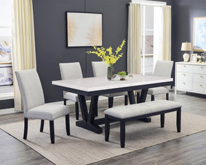 A fresh take on a traditional silhouette makes this group a great addition to your dining space. A genuine marble top is luxurious and timeless. The trestle base is updated in a contemporary charcoal finish. The upholstered dining chairs feature gently sl
