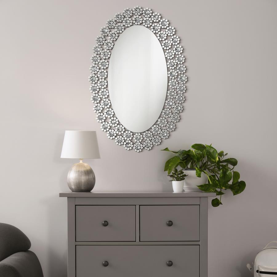 Radiate elegance with this striking oval wall mirror adorned in dazzling faux crystal blossoms. A stunning blend of modern glamour and floral charm, it brightens up any room with its reflective surface and sparkling frame. Perfect for entryways, bathrooms