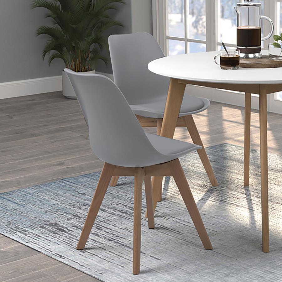 Elevate your dining space with this sleek, mid-century modern side chair. Featuring a smooth, grey faux leather seat and angled oak wood legs, it delivers style and durability. The padded shell offers lasting comfort, while the heat- and stress-resistant 