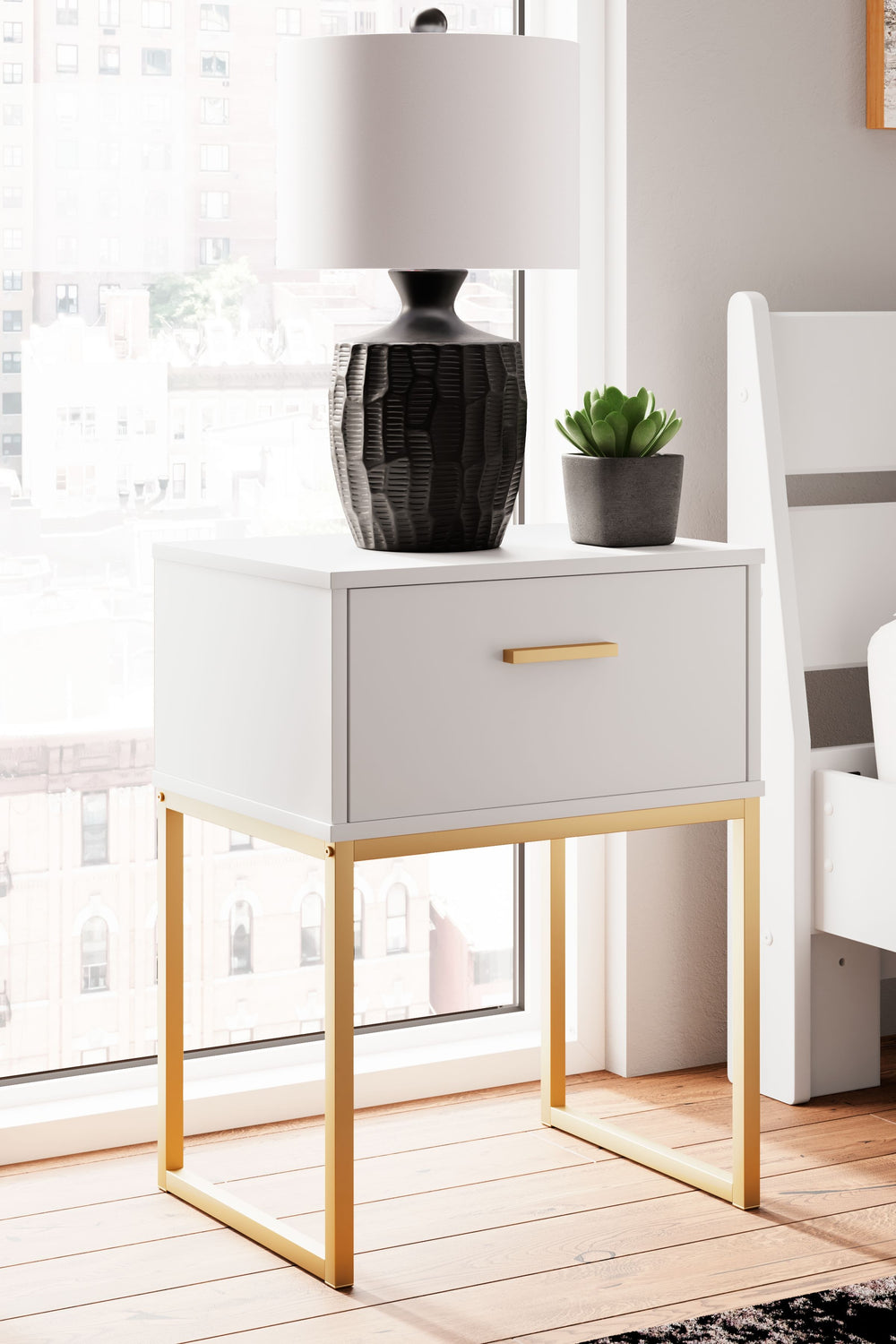 Light and bright, this nightstand is inspired by chic design. A matte white finish and goldtone accents offer an elegant touch to this so-cool piece. It beautifully blends the hues of natural living with the edginess of your modern lifestyle.<br/><br/><b>