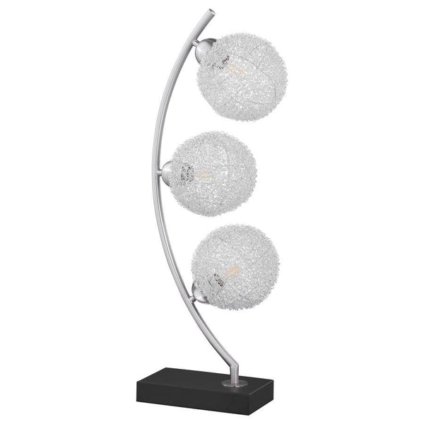 Graceful silhouetting pairs with a trio of elegant wire frame orb shades in a modern table lamp. Designed to make an impact on a console or side table, it features a fresh, modern look complete with a vertical arc frame in a chrome finish. The arc hosts t