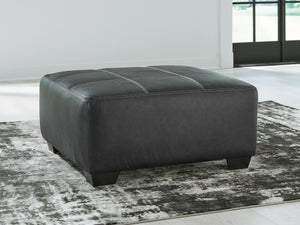 it pairs cozy fabric with faux leather for invitingly cool character. And with its robust size offering extra legroom