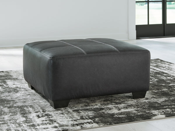  it pairs cozy fabric with faux leather for invitingly cool character. And with its robust size offering extra legroom