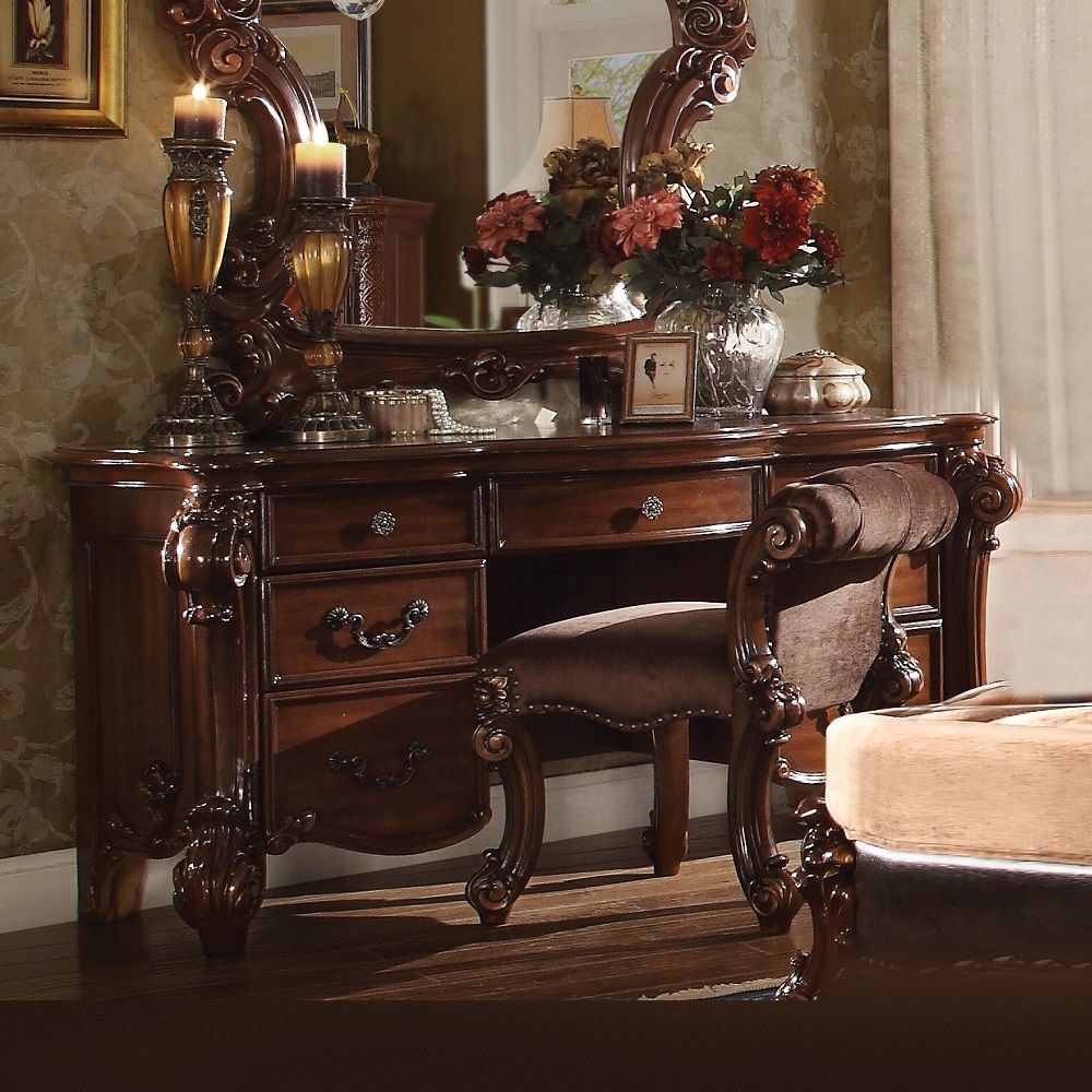 Create an elegant, traditional design in your bedroom with the cherry Vendome vanity desk. This hand-crafted piece inspired from the luxurious designs of the past, this seven-drawer, desk features elaborate wood carving details, traditional hardware and a