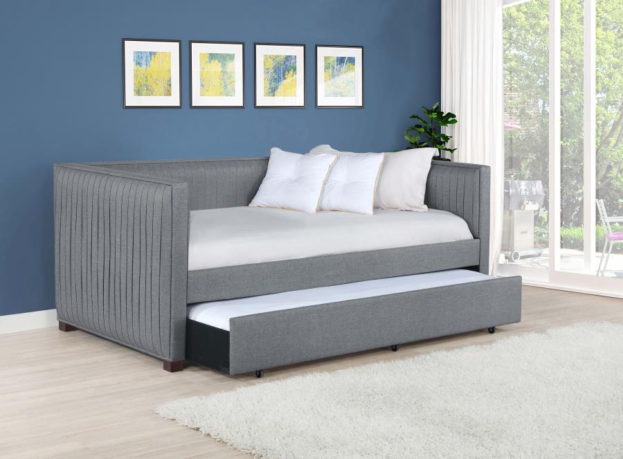 A gray fabric, pleated and overlapping along the surface of this twin daybed and trundle set, create a textured appearance against the clean straight lines. The narrow arms and backrest invite you to get creative with your own accent pillows and throws, o