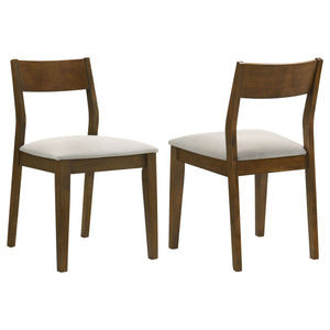 Angular design highlights a set of two modern dining chairs. Each boasts an armless silhouette, pairing an open wood back with a plush seat cushion. Foam padding and beige upholstery create incredible comfort and support, perfect for quick bites and leisu