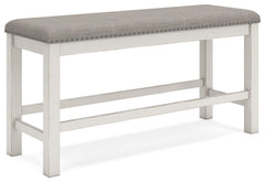 This counter height dining bench is sure to impress come mealtime. With its white finish and light gray upholstery, farmhouse-style seating has never been so fashionable. All thatâ€™s missing is you and your family.<br/><br/><b>Product Features</b><ul><li