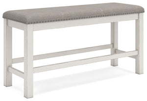 This counter height dining bench is sure to impress come mealtime. With its white finish and light gray upholstery, farmhouse-style seating has never been so fashionable. All thatâ€™s missing is you and your family.<br/><br/><b>Product Features</b><ul><li