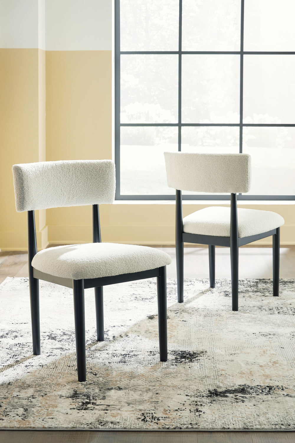 Clean lines meet cool curves with this dining chair. Simple round post legs and a black finish lend a modern vibe, while softly textured upholstery tempts you to sit and stay awhile. What a delicious choice for a dining room update.<br><br><b>Additional D