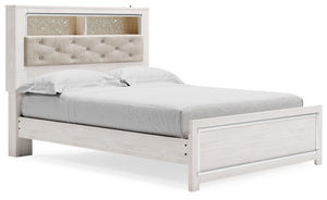 The epitome of fashion-forward design, this queen upholstered bookcase bed is a beautiful blend of comfort and luxury. Shiny chrome-tone accents, a pearlized finish and button-tufted upholstery bring a glam touch to the richly rustic appearance. Remote-co