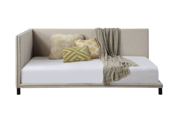 Clean lines, simplicity, and natural color create a calm, relaxing space where you can escape from your daily routine. The daybed is fully upholstered in beige linen for a light and airy feel. Nailhead trim detailing along the border enhances the elegant 