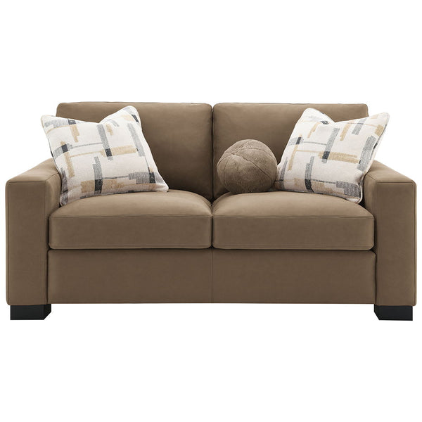  featuring plush pillows and wrapped in luxurious brown suede fabric. Its inviting design and soft