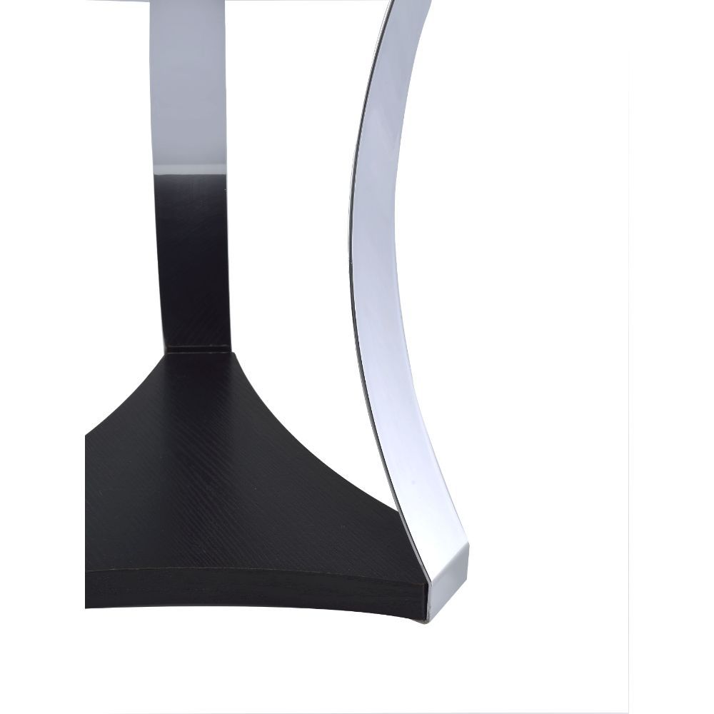 The Geiger coffee table expresses modern design and simplicity while still being functional and a conversation table. It features soft curved metal legs supporting a black glass top and a reverse cut base. The bottom wooden shelf gives you additional spac