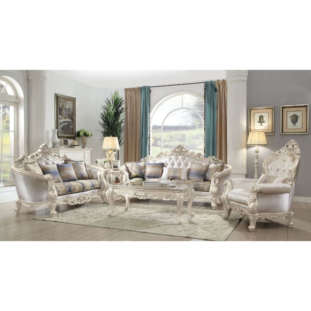 Exclusively designed and filled with romantic spirit, this beautiful sofa features Queen Anne legs and carved aprons and trims, decorated with raised and scrolled floral motifs in an antique champagne finish. Each piece of this sophisticated living room s