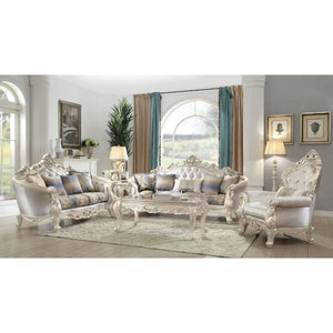 Exclusively designed and filled with romantic spirit, this beautiful sofa features Queen Anne legs and carved aprons and trims, decorated with raised and scrolled floral motifs in an antique champagne finish. Each piece of this sophisticated living room s