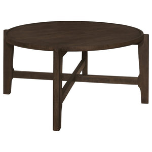 Circled by the day-'s activity, the coffee table is a cocktail centerpiece that grounds the room in solid wood durability. Its dark brown finish glows under the touch of light, inviting a caress to its smooth, subtly recessed surface. The strong, intersec