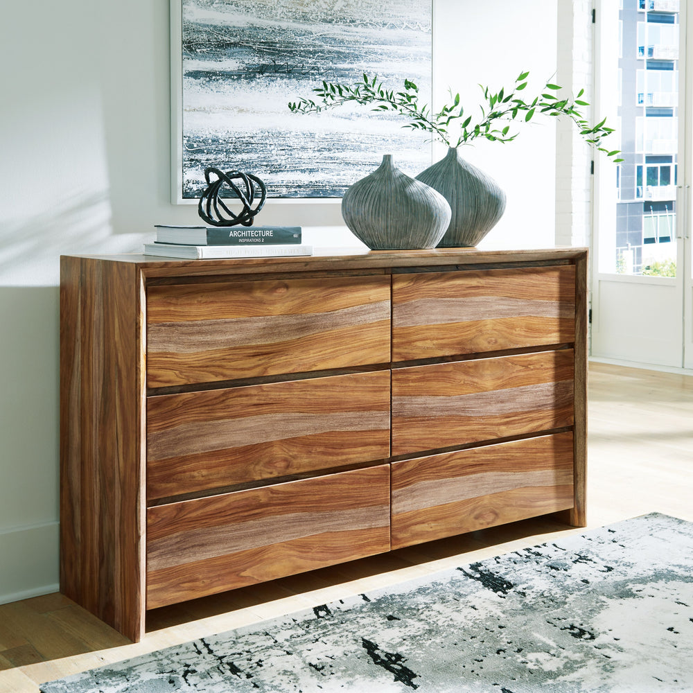 Discover something extraordinary with this clean-lined dresser. The rich natural beauty of the wood, enhanced with a clear wood-tone finish, brings an organically stunning vibe to your bedroom. Strikingly simple drawers lend a hand with keeping your wardr