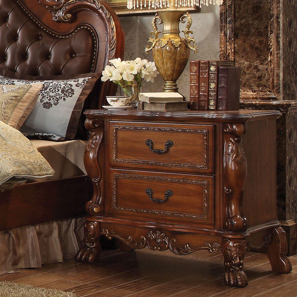 The Dresden Nightstand in Cherry Oak offers beautiful craftsmanship and artistic carvings. It features solid hardwood with two drawers for storage with coordinating carvings. The drawers feature dove tail construction and are decorated with antique brass 