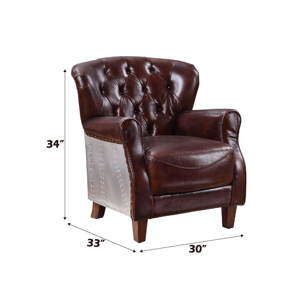 The Brancaster accent chair invites you to sit back and relax for hours on end. A timeless design, this armchair features vintage brown top grain leather upholstery with button-tufted accents, rolled arms, and tapered wood legs. Whether your decor leans t