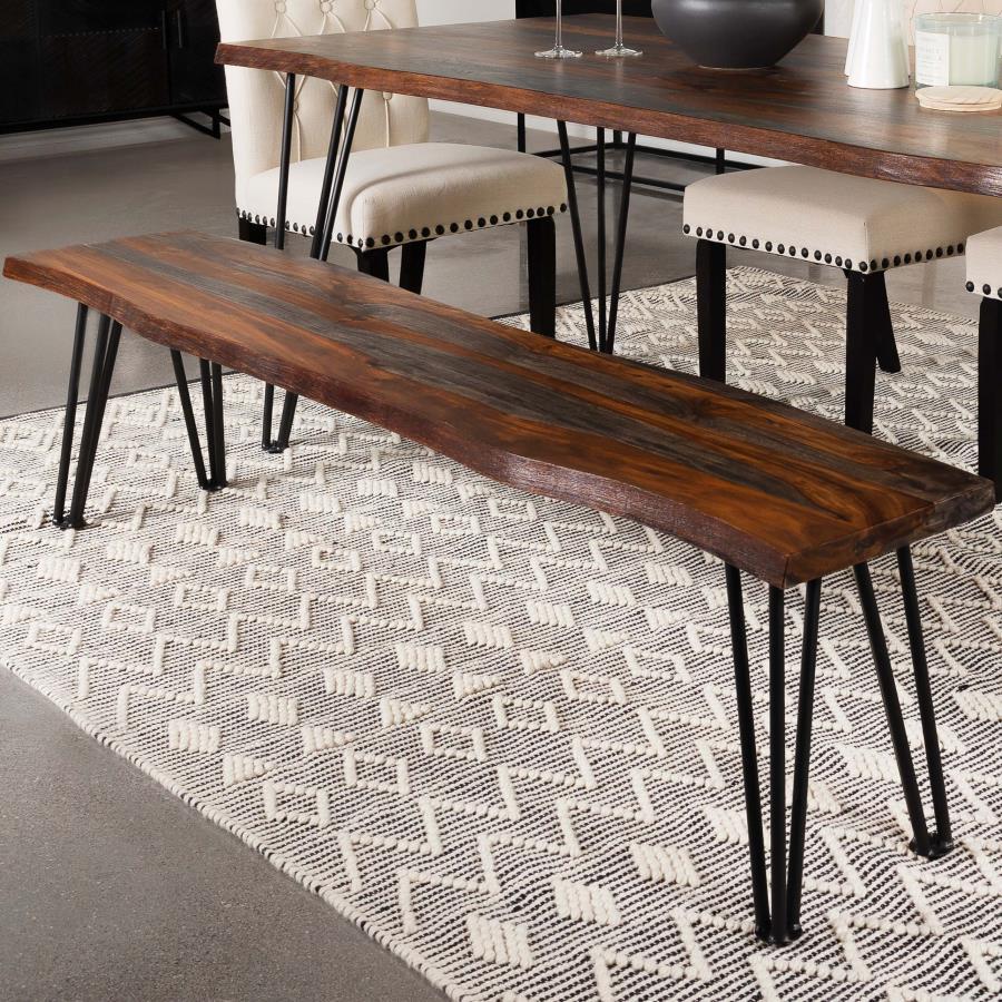 Present plenty of seating at your transitional dining table with this rustic industrial dining bench, featuring a long solid sheesham wood seat covered in a grey finish complete with a live-edge detail that gives a natural touch. Gunmetal finished hairpin