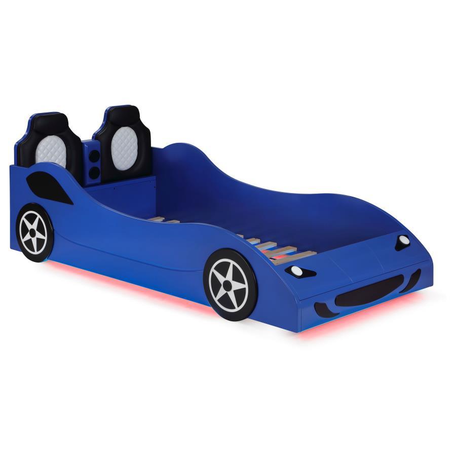 Modern race car aesthetics inform the design of a novelty car bed perfect for kids. Its twin size is versatile, allowing for plenty of space to play within the bedroom. The car is complete with realistic details and features LED strip lighting underneath,
