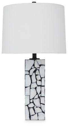 This exquisite table lamp is artfully adorned, with a mosaic pattern of white marble playing beautifully against a black background. Complemented by a modified drum shade for a sophisticated sensibility, the lamp casts an elegant glow in the entryway or l