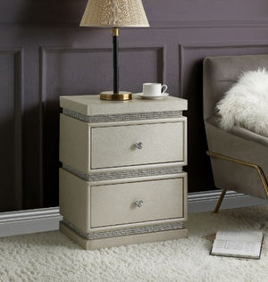 Add a stylish touch with the Lotus Accent Table that combines traditional elegance and modern glamour. The table border is detailed with shimmering faux diamonds that make it stand out in a luxe-glam style. It offers two storage drawers with safety stop a