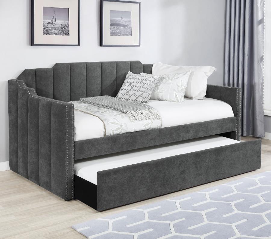 Welcome guests to stay for the night with this contemporary twin daybed and trundle set. Wrapped entirely in a charcoal gray velvet fabric with an Art Deco-inspired channel tufted design and stepped edges, this twin daybed is as stylish as it is comfortab