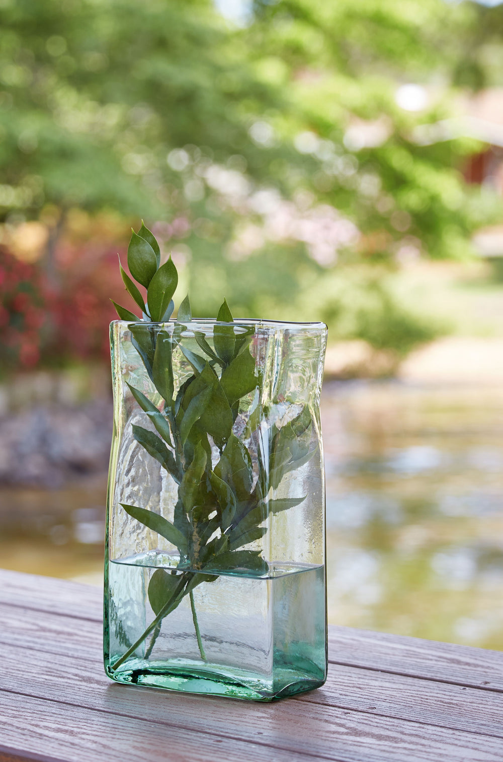 This vase, made of transparent green glass, provides a sturdy foundation for a full bouquet of your favorite long-stemmed blooms. With a fluted wide opening, the beautiful vessel provides ample room to place flowers perfectly. Or use it with flameless can