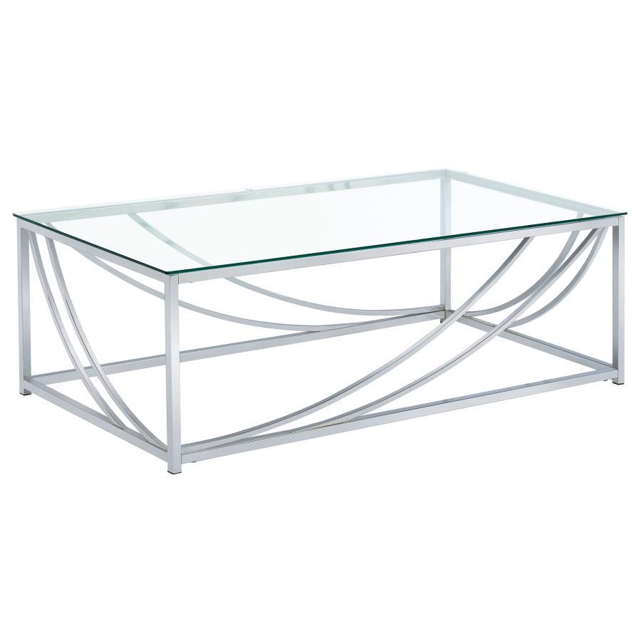 This rectangular coffee table boasts a modern design with a clear tempered glass top that highlights its sleek aesthetic. The sturdy metal frame, finished in electroplated polished chrome, features gracefully curved accents for an elegant touch. Its minim
