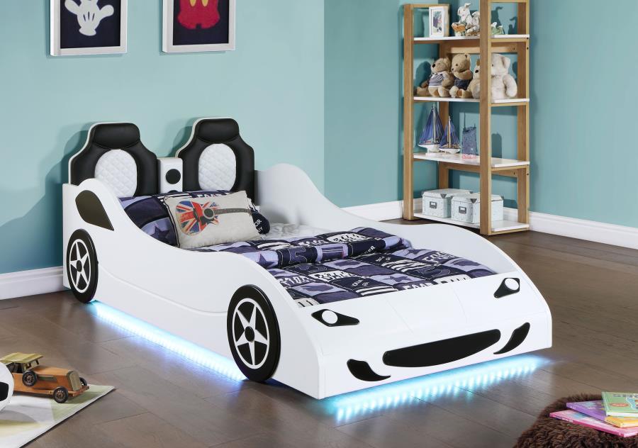 Modern race car aesthetics inform the design of a novelty car bed perfect for kids. Its twin size is versatile, allowing for plenty of space to play within the bedroom. The car is complete with realistic details and features LED strip lighting underneath,