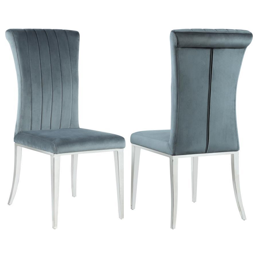 Elevate your dining experience with this refined side chair, upholstered in rich grey velvet for a luxe look and feel. The tall, gently rolled back adds graceful elegance, while vertical tufting brings tailored detail. Its cushioned seat offers comfort, a