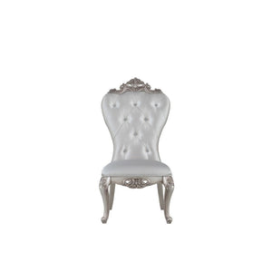 Exclusively designed and filled with romantic spirit, this beautiful chair features Queen Anne legs and carved apron and trim, decorated with raised and scrolled floral motifs in an antique champagne finish. This unique chair is upholstered in a cream fab
