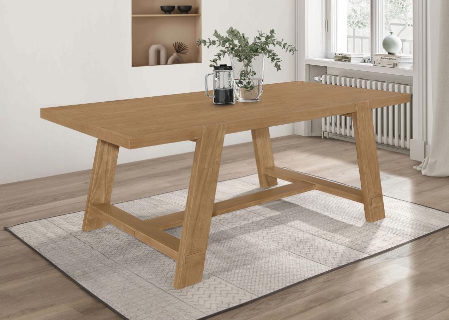 Elevate your dining room with the captivating blend of modern farmhouse style in this stunning dining table. The brown wire-brushed finish highlights the natural beauty of the wood, adding warmth and character. The open, airy U-shaped legs and wide trestl