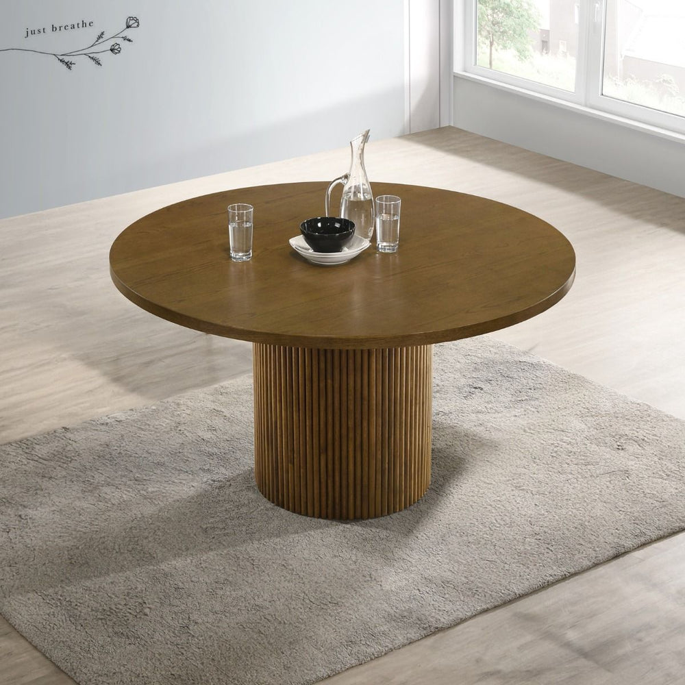 This round dining table exudes modern elegance with its rich walnut finish and sophisticated design. The single pedestal base features vertical striations, adding a touch of texture and visual interest. Hezrai perfect for intimate dinners and family gathe