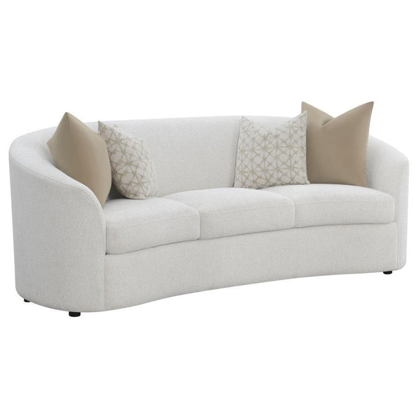 Create your inviting living room with this curved contemporary sofa, upholstered in a softly textured latte boucle upholstery throughout its elegantly designed, contoured silhouette and sloped armrests. Matching accent pillows with premium faux down fill 