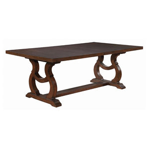 A decorative base is the highlight of this stylish transitional wood dining table. Featuring a rectangular silhouette measuring just over 104 inches, the table easily accommodates eight for everything from a quick breakfast to a holiday feast. Intriguing 