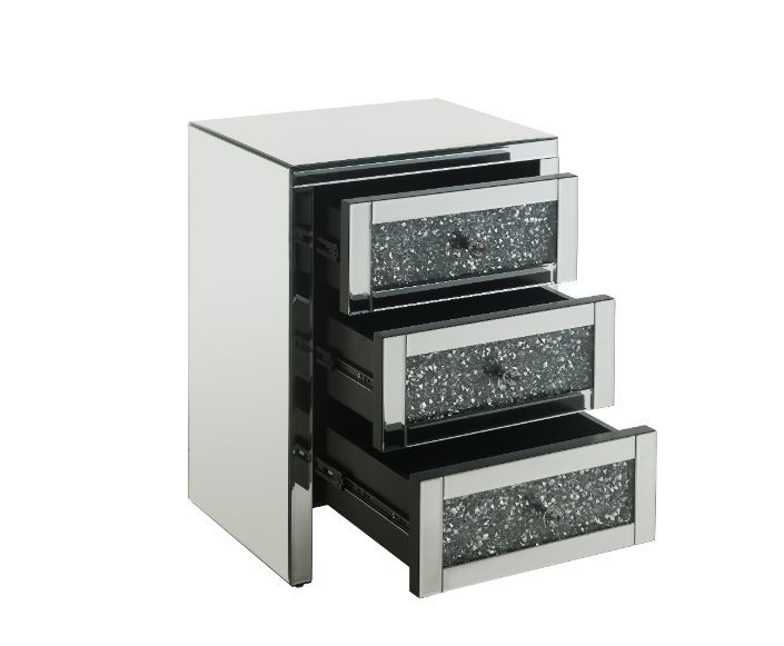 The Noralie Accent Table will give any room a touch of glamour. Mirror and glass materials give it a modern and clear touch while faux diamond inlays add glam style to this piece. Use this unique piece as the perfect accent for any room dÃ©cor. It has thr