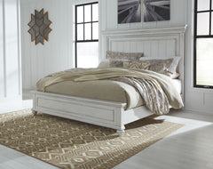 Give your retreat vintage charm with this queen panel bed. In a beautifully distressed whitewash finish, you-'ll love the headboard-'s grand style featuring a picture framed panel. Generously scaled moulding from top to bottom, along with bun feet give th