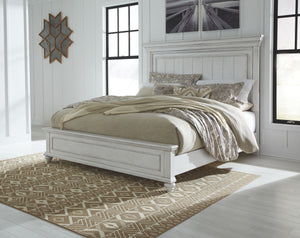 Give your retreat vintage charm with this queen panel bed. In a beautifully distressed whitewash finish, you-'ll love the headboard-'s grand style featuring a picture framed panel. Generously scaled moulding from top to bottom, along with bun feet give th