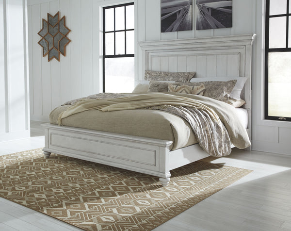 Give your retreat vintage charm with this queen panel bed. In a beautifully distressed whitewash finish, you-'ll love the headboard-'s grand style featuring a picture framed panel. Generously scaled moulding from top to bottom, along with bun feet give th