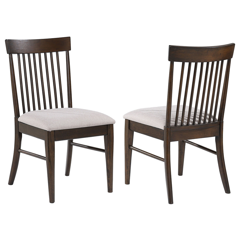 Neutral wheat upholstery sets a refined tone for a set of two mid-century dining side chairs. The armless chairs offer comfortable seating for your kitchen or dining room. Each features a foam padded seat that pairs perfectly with a classic spindle back. 
