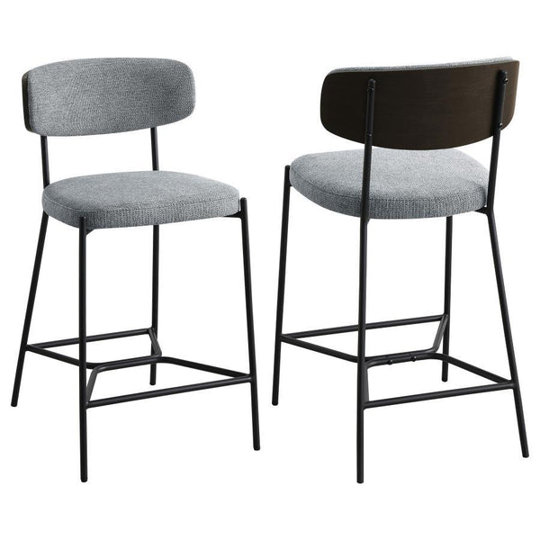 Introduce comfort and style with a set of two contemporary counter stools for your kitchen. Each features a black finish metal frame, offering streamlined character with slim structure and geometric details. Light, neutral upholstery covers foam cushions,