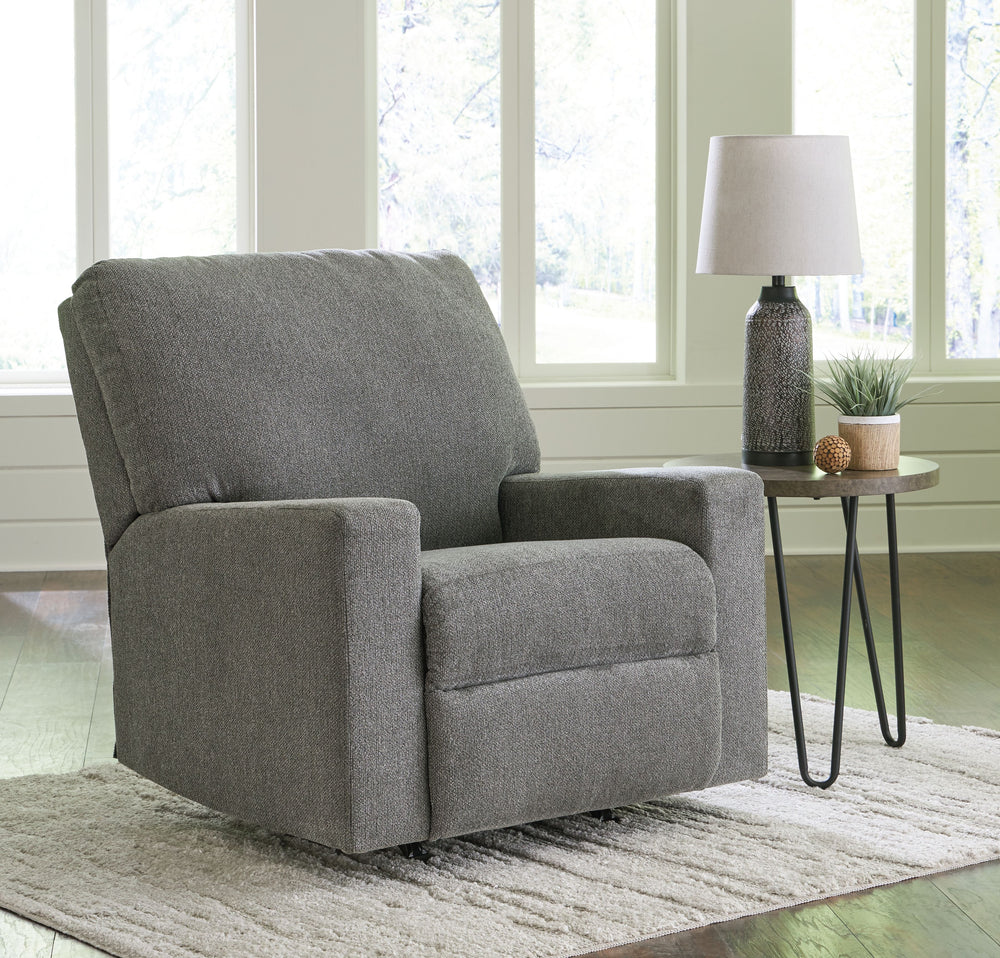 Youâ€™re in for a neat treat with this rocker recliner. Its comfy seat is covered in soft, textural upholstery, and the wide track arms are eager to support your quest for total relaxation. A side button reclines the seating to a relaxing position. Or sim