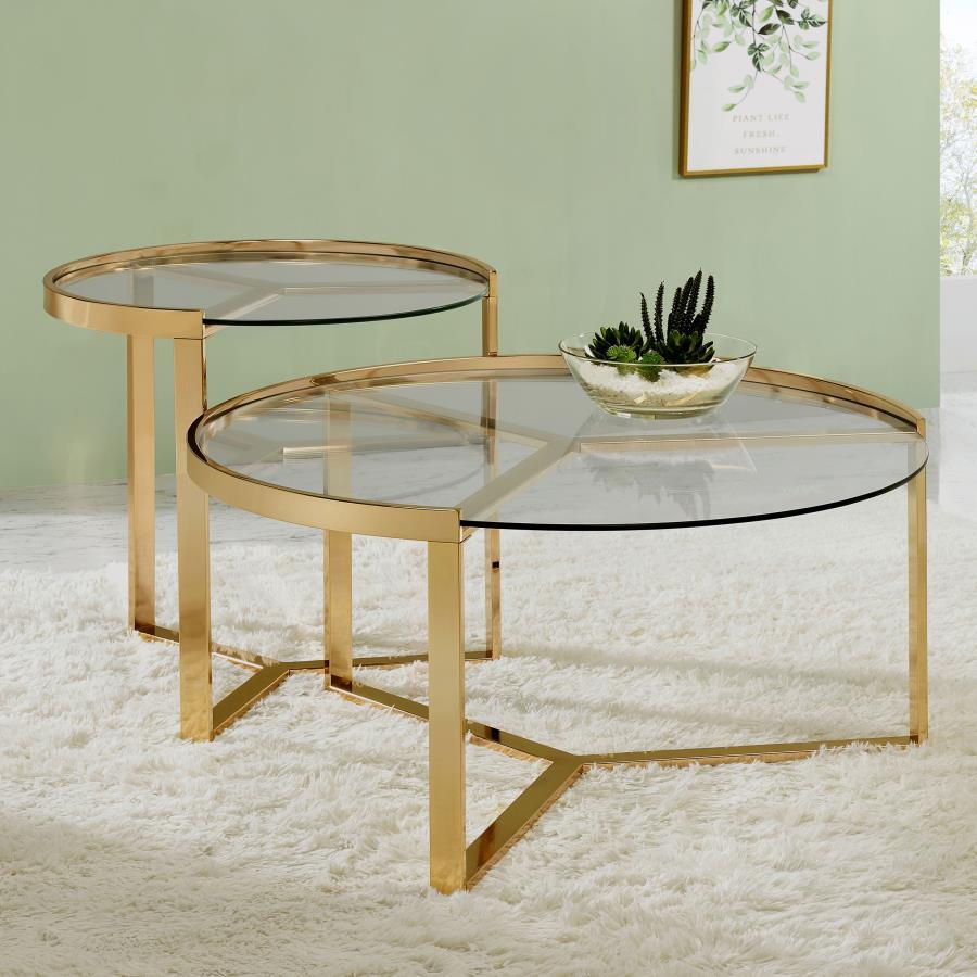 Embrace the elegance of this nesting coffee table set, where sleek round clear tempered glass tops rest gracefully atop a shimmering gold electroplated metal base. The modern, refined design captures a perfect balance of beauty and function, creating an e