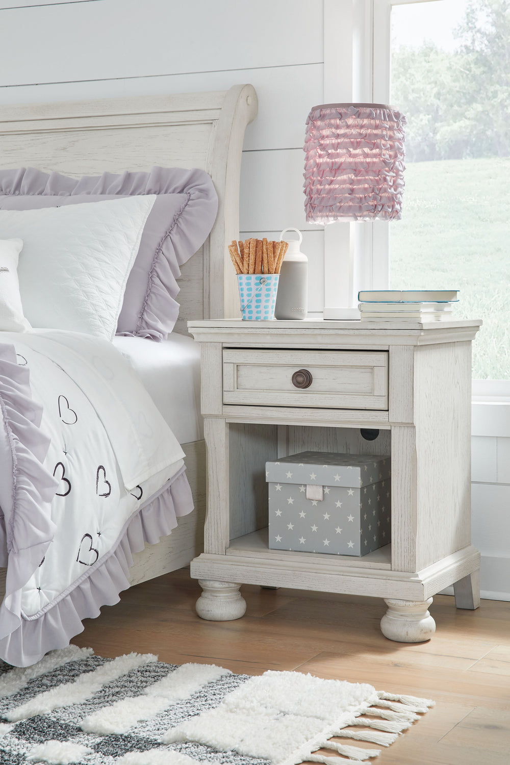 Elegant, timeless furnishings take your bedroom to the next level. Nothing does that better than this nightstand. The antiqued white finish with a wonderful grain texture radiates sophistication, while a dark bronze-tone knob adds an ornate touch. A singl